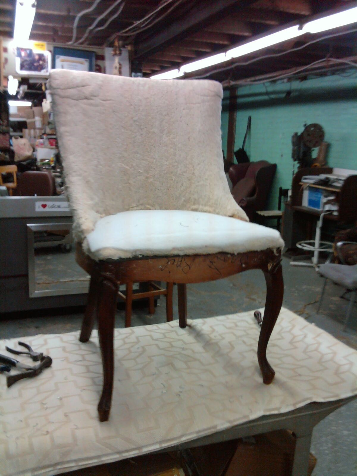 Side chair with cabriole legs on the workbench, back and seat rebuilt to fresh padding